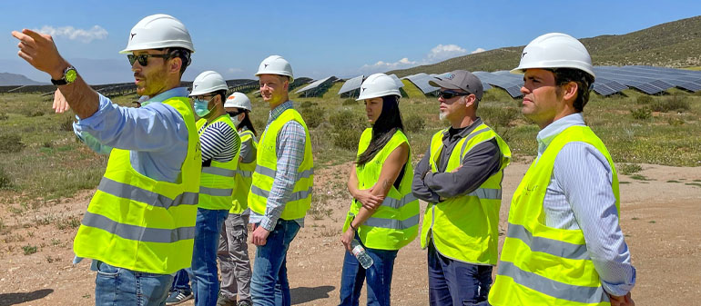 Construction workers with protective vests and helmets looking at something